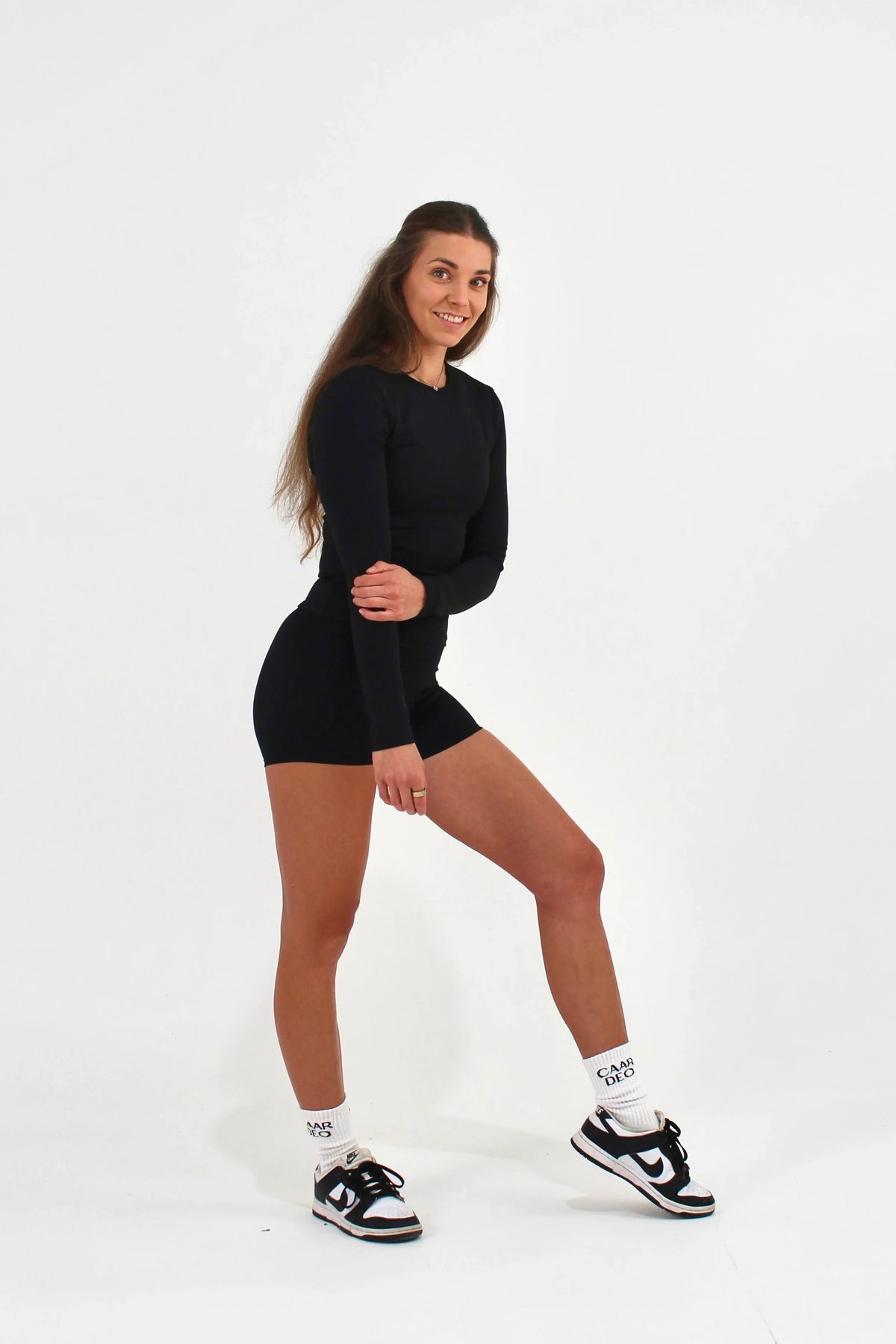 Woman wearing a black FORM long sleeve top by CAARDEO Active