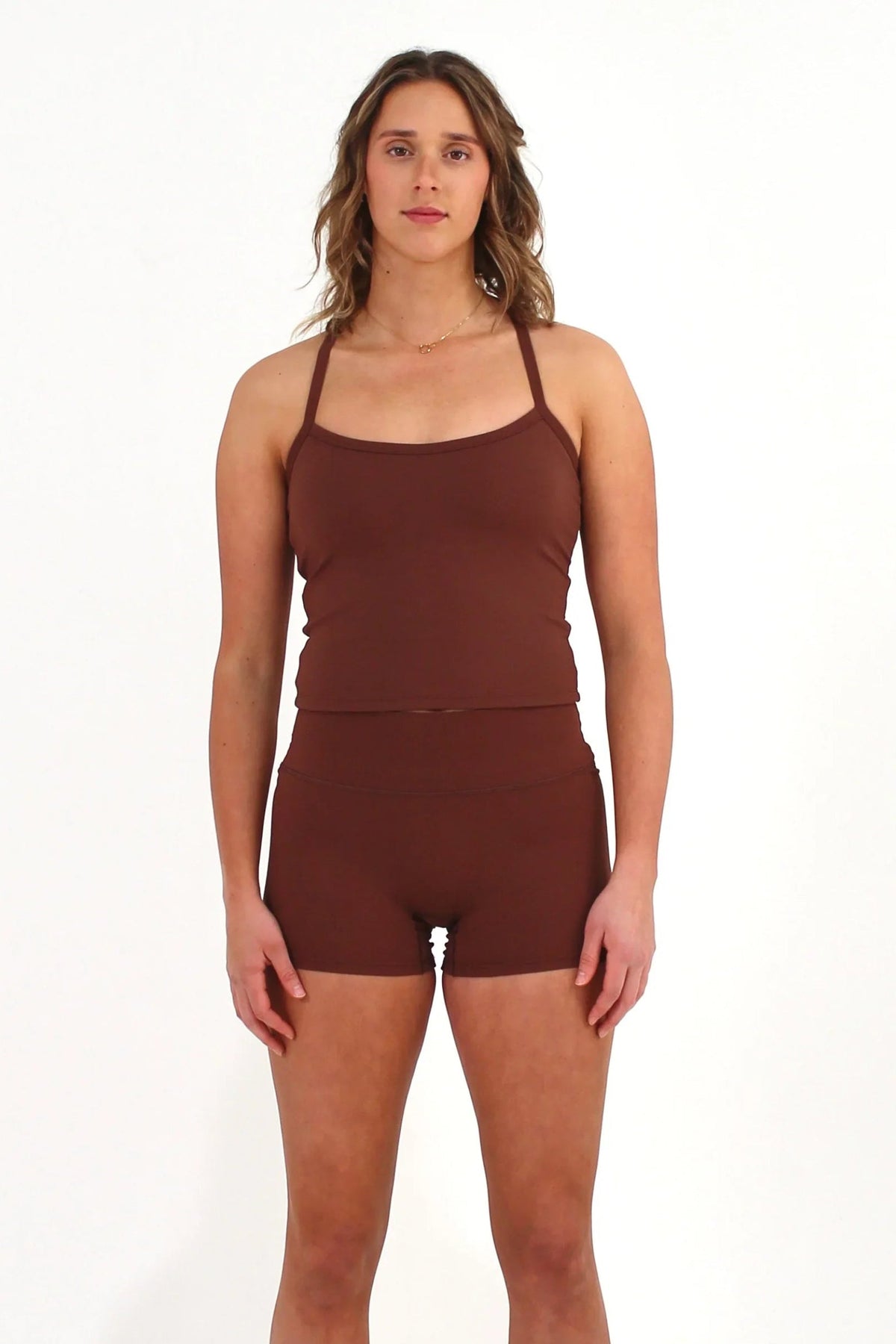 Woman wearing brown FORM shorts by CAARDEO Active