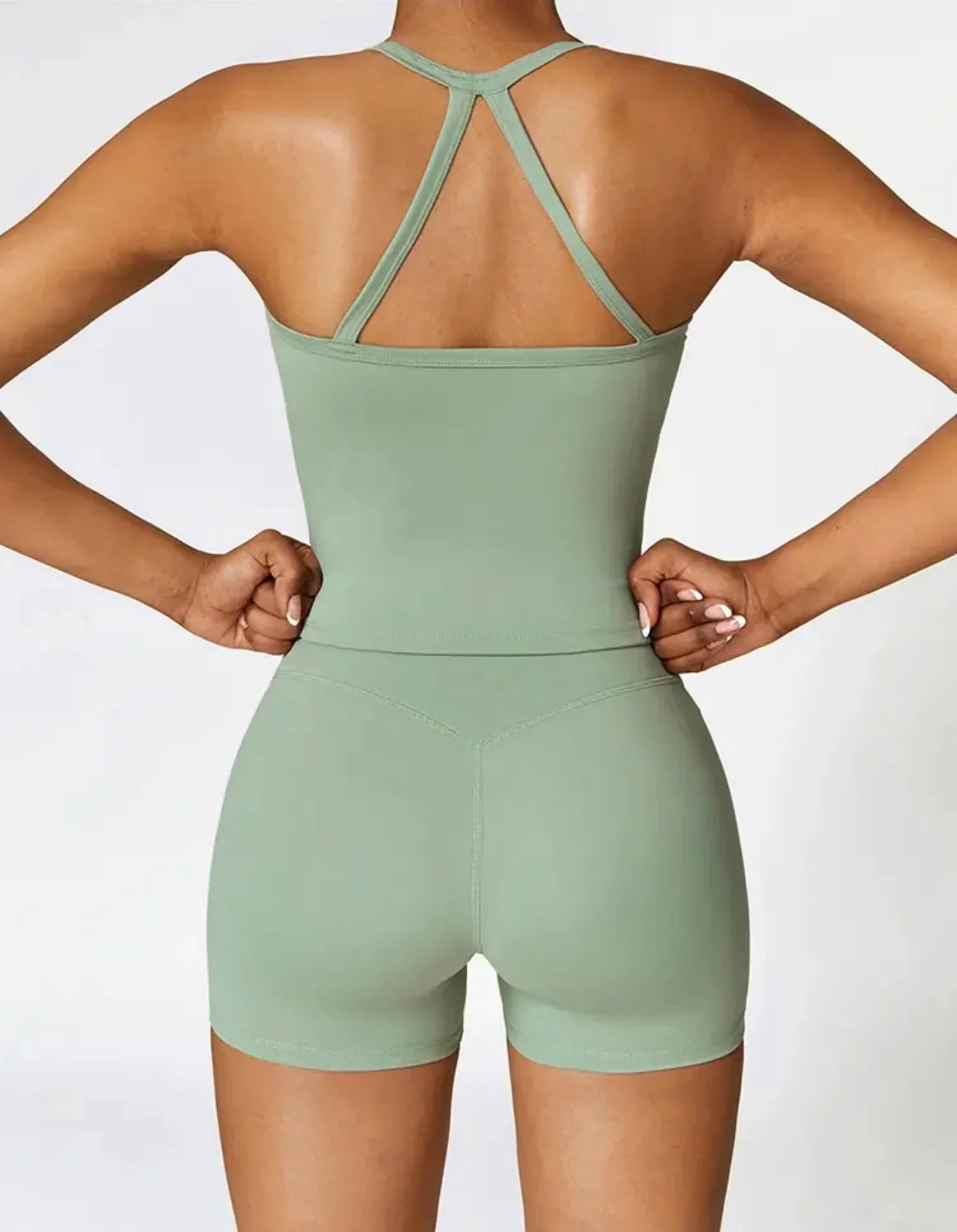 Woman wearing a green FORM crop top by CAARDEO Active