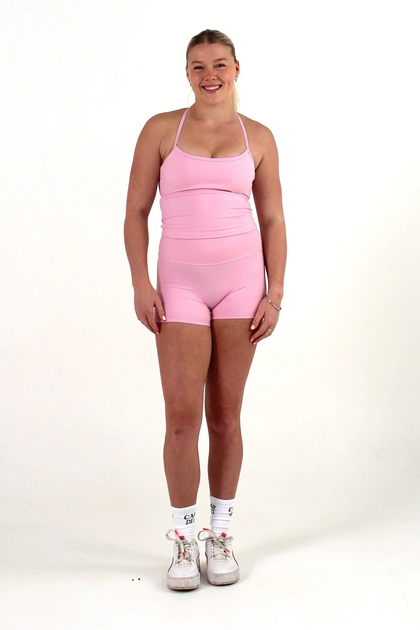 Woman wearing pink FORM shorts by CAARDEO Active