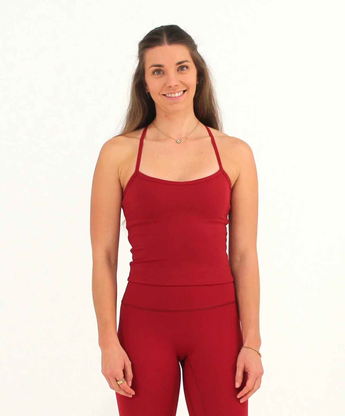 Woman wearing a red FORM crop top by CAARDEO Active