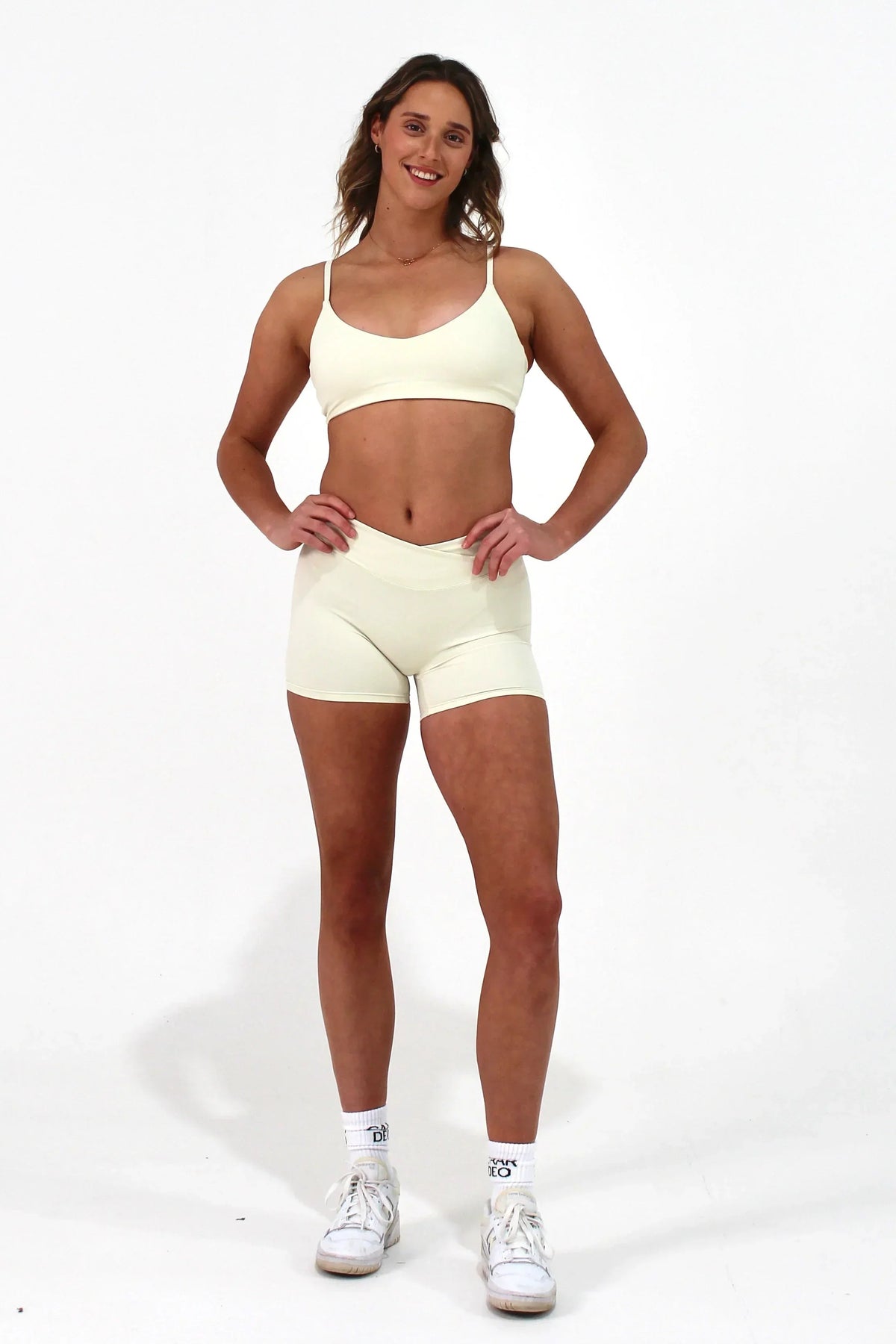 Woman wearing vanilla ELEVATE Shorts by CAARDEO Active