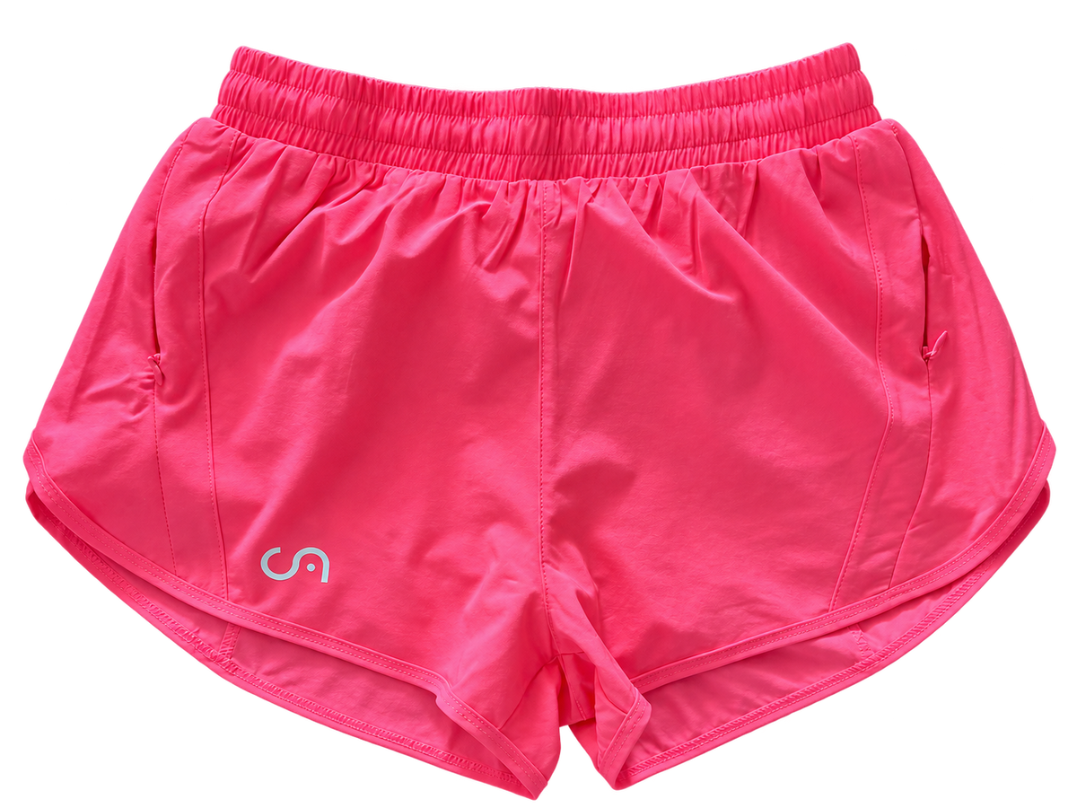 Bright pink athletic shorts with an elastic waistband and a small white stylized logo on the lower left leg, shown against a plain white background.