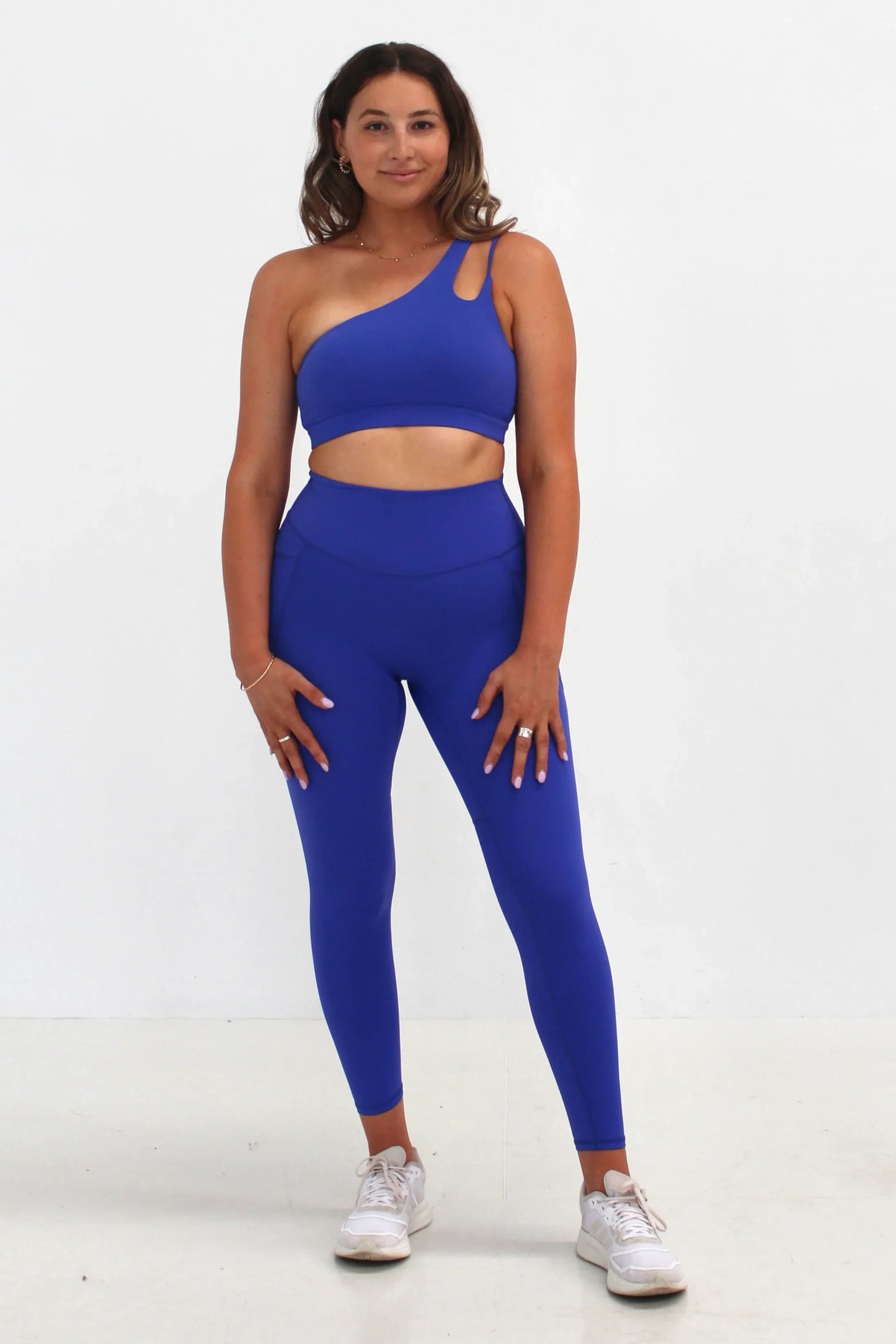 Woman wearing cobalt SECOND SKIN leggings with side pockets by CAARDEO Active