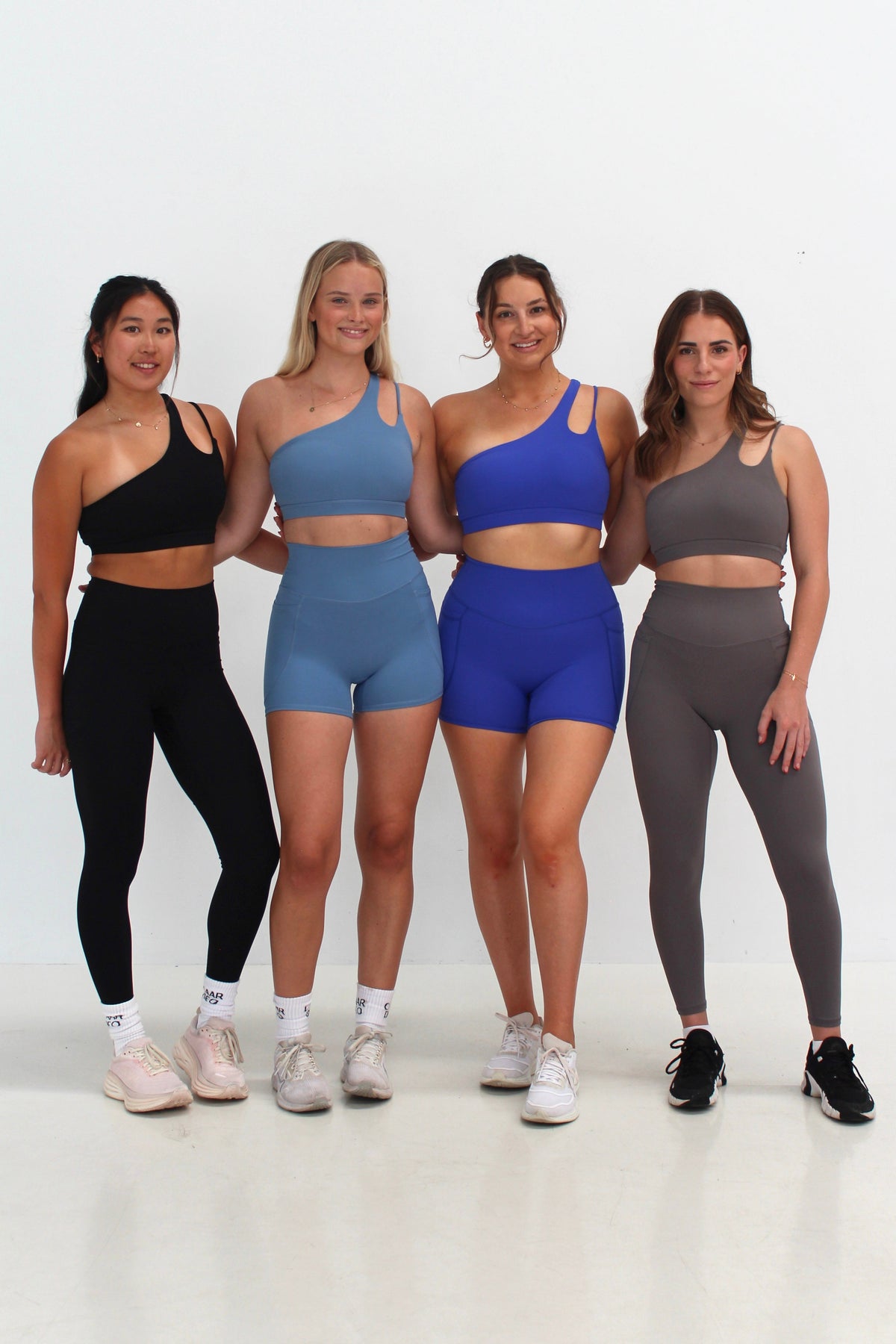 Women wearing SECOND SKIN leggings, shorts and crop tops by CAARDEO Active