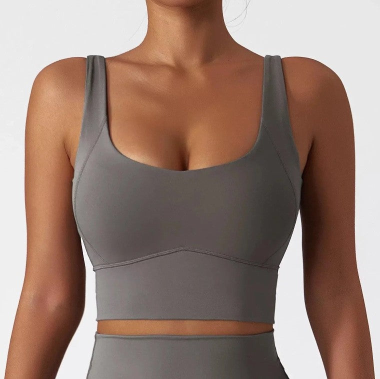 Woman wearing grey SECOND SKIN scoop neck crop top by CAARDEO Active