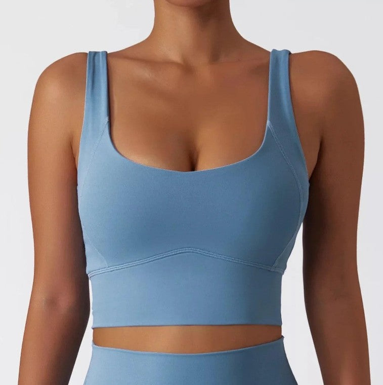 Woman wearing sky blue SECOND SKIN scoop neck crop top by CAARDEO Active