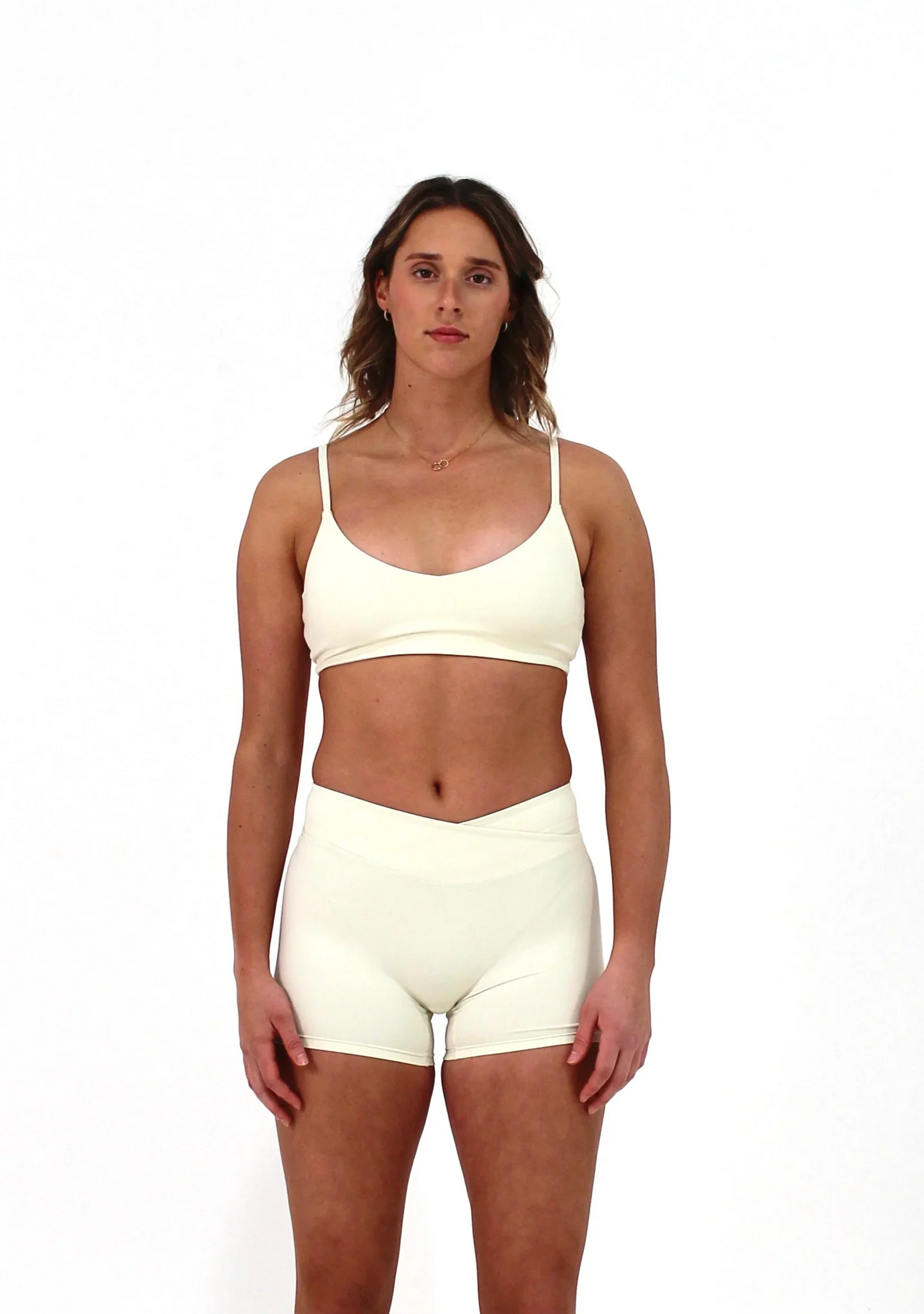 Woman wearing vanilla ELEVATE Crop by CAARDEO Active
