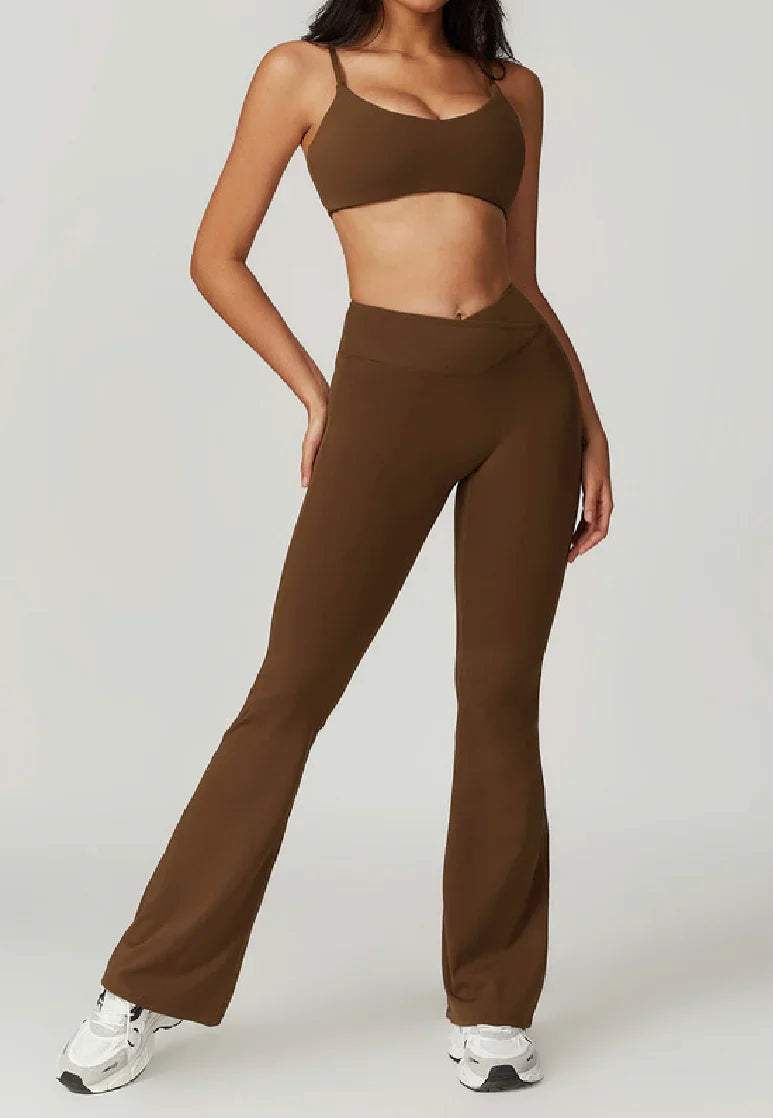 Woman wearing brown high-waisted ELEVATE Flare Leggings by CAARDEO Active