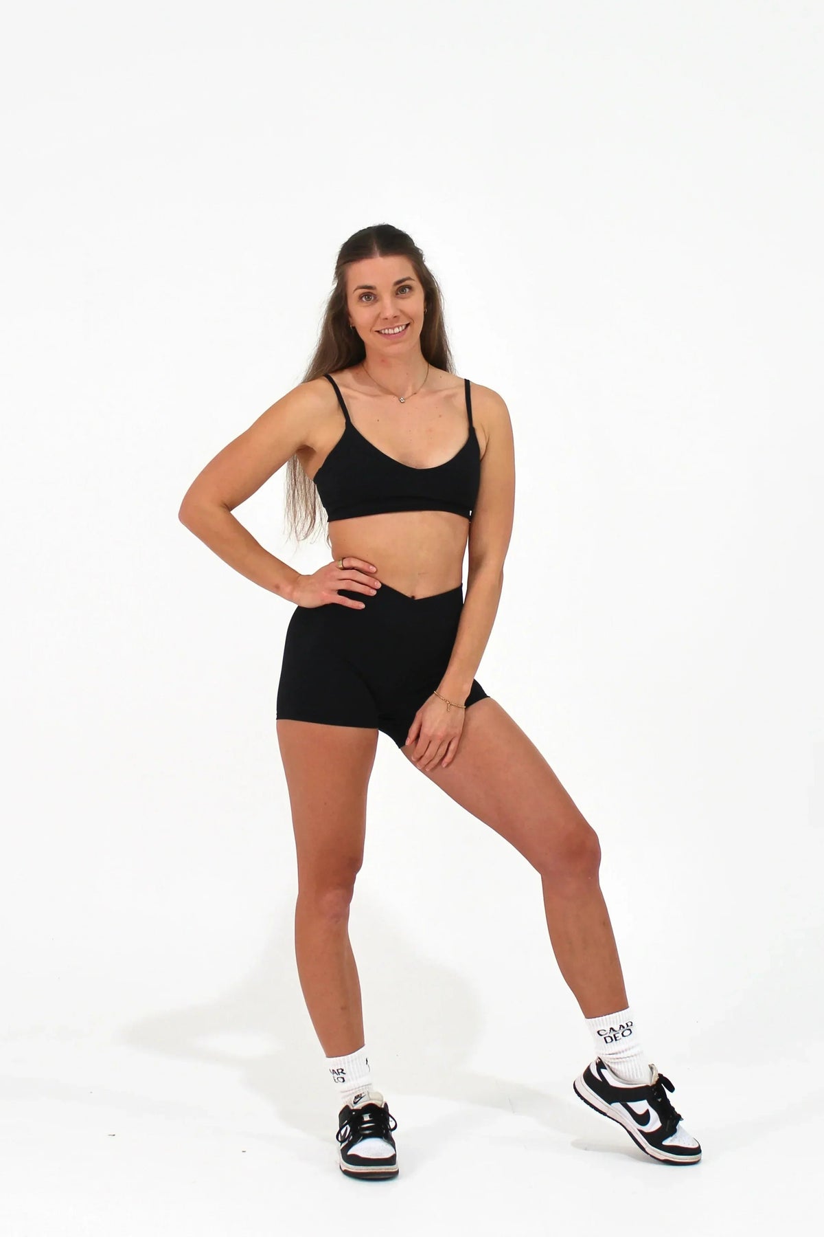 Woman wearing black ELEVATE Shorts by CAARDEO Active