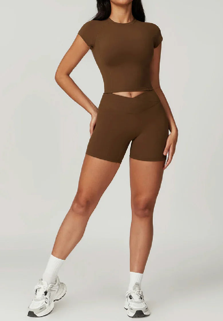 Woman wearing cropped brown ELEVATE Top by CAARDEO Active