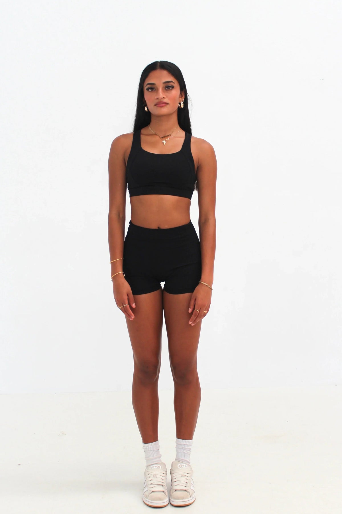 Woman wearing black high-waisted SCULPT Shorts by CAARDEO Active