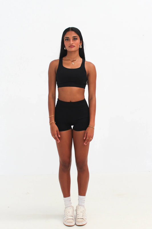Woman wearing black high-waisted SCULPT Shorts by CAARDEO Active