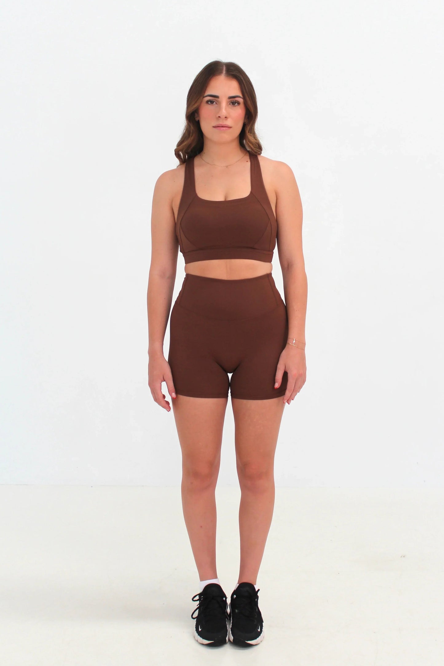 Woman wearing Spring Brown high-waisted SCULPT Shorts by CAARDEO Active